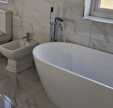 Freestanding bath with running tap by AG Signature Renovation