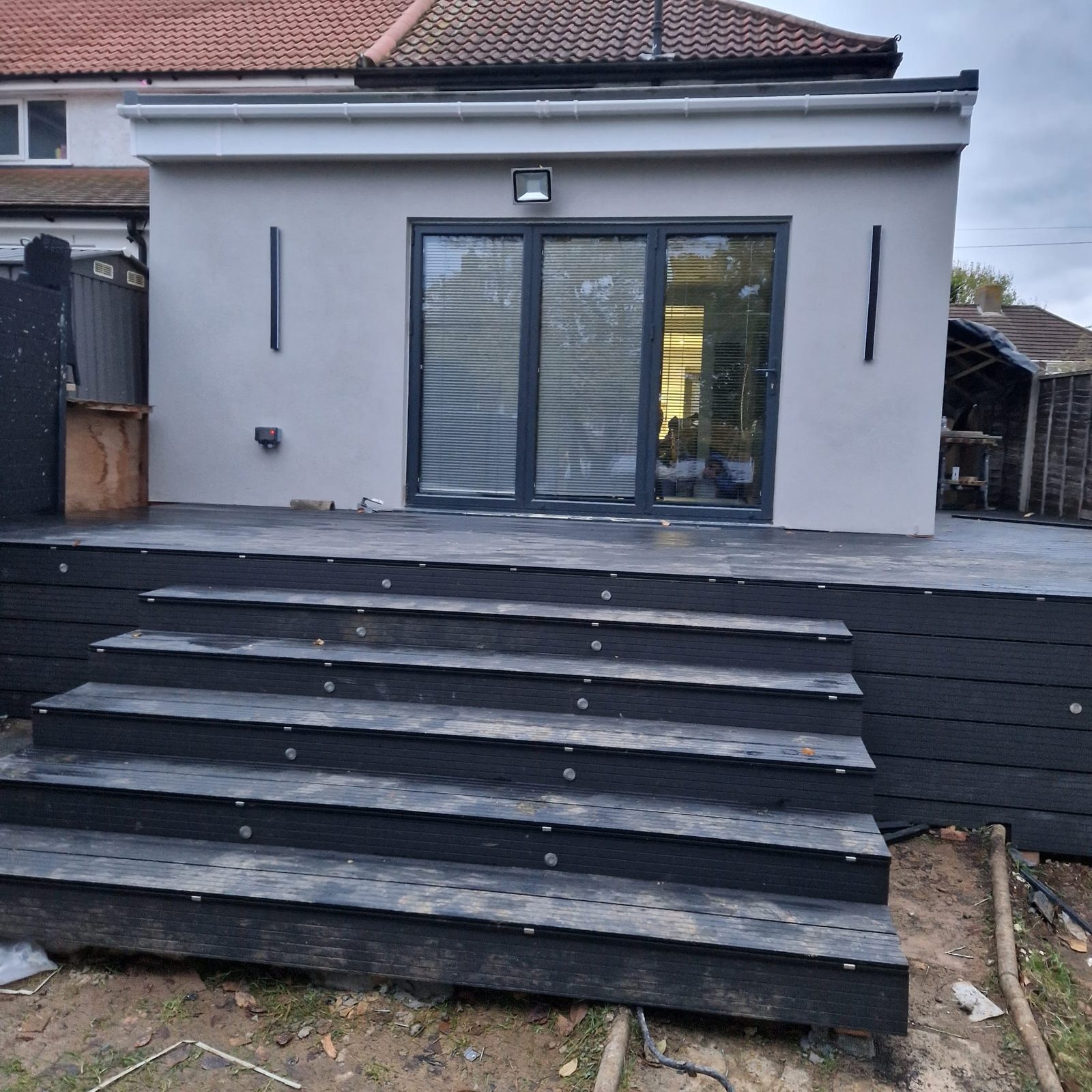 Grey rendered rear extension with composite decked steps