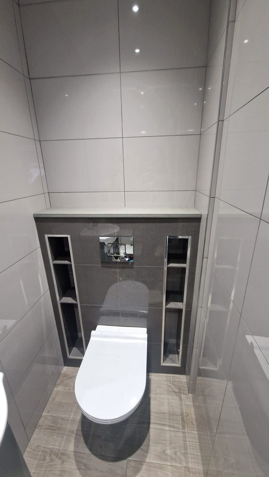 Marble-tiled WC with concealed cistern by AG Signature Renovation